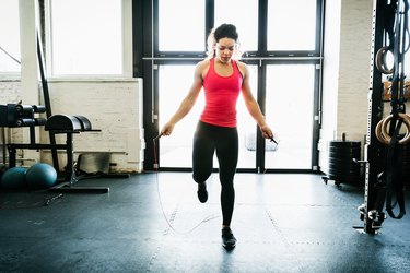 Young Woman Using Skipping Rope To Keep Fit