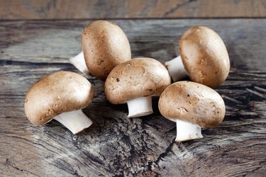 Vitamin D-rich cremini mushrooms on wooden table