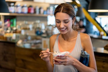 Woman eating a healthy snack at the gym