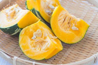 a close up photo of a quartered Kabocha squash