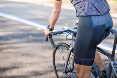 Cyclist riding bike in public park for a cycling workout