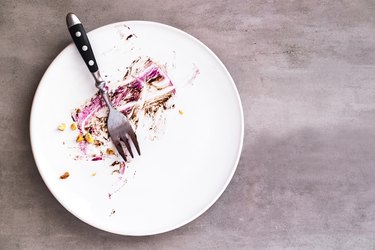 White empty plate with crumbs after fasting
