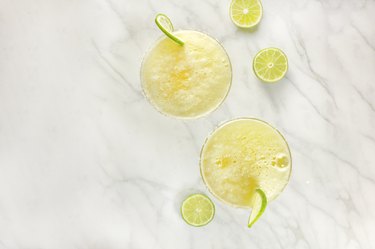 Lemon Margarita cocktails with limes and copy space