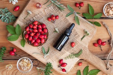 A bottle of rosehip seed oil with sage, wormwood, winter savory and other herbs