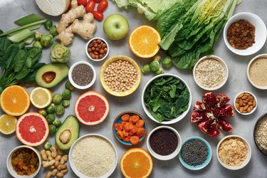Set clean eating. Vegetarian healthy food - different vegetables and fruits, superfood, seeds, cereal, leaf vegetable on light background, top view. Flat lay