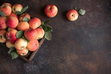 Red apples in wooden box