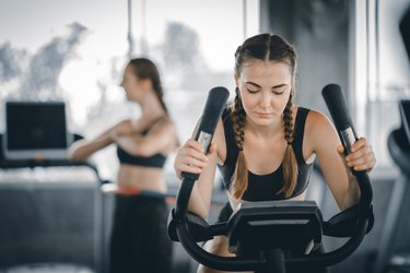 Young Woman Exercising In Gym
