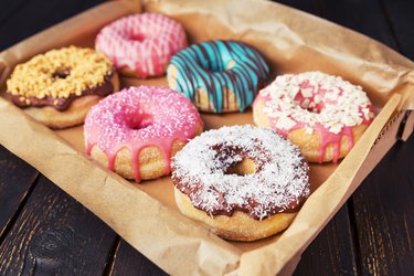 Fresh homemade donuts with various toppings, as an example of foods to avoid with reactive hypoglycemia