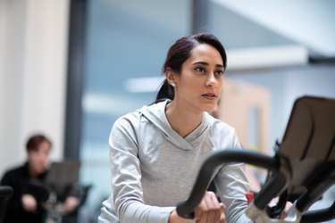 A diverse group of people doing a spin class