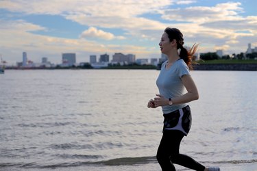 Young beautiful female running on the beach