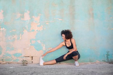 Girl doing stretching in the street