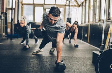 A man working out with dumbbells in the gym