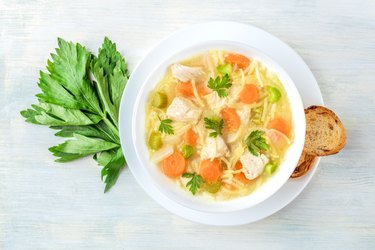 Chicken noodle soup, shot from the top with toasted bread