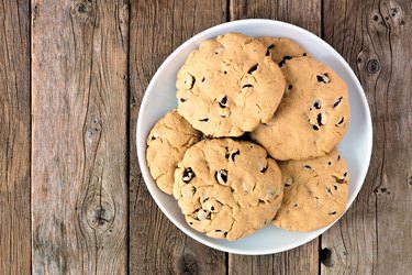 Plate of traditional chocolate chip cookies on rustic wood