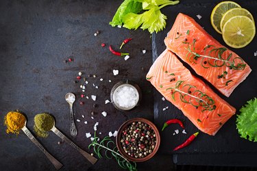 Raw salmon fillet and ingredients for cooking