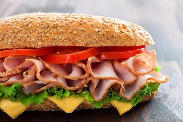 Delicious sandwich with tomato, cheese, lettuce and turkey