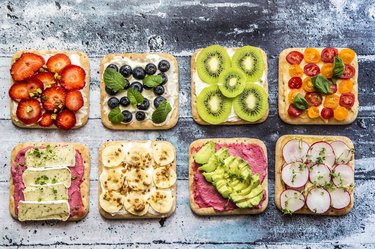 Two rows of various garnished sandwiches