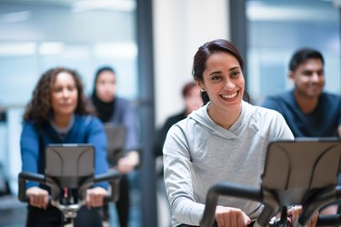 A diverse group of people doing a spin class