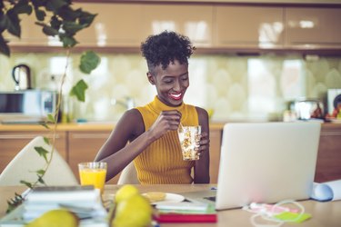 Person working in their home office eating breakfast