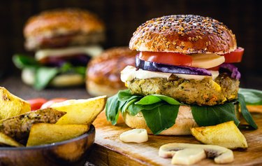 Prepared gluten-free veggie burgers with thick fries on platter.