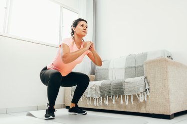 Woman doing squat exercise.