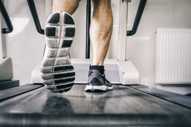 Austria, Klagenfurt, man running on treadmill