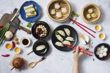 Flat lay Chinese new year reunion dinner, food and drink. Marble top background.