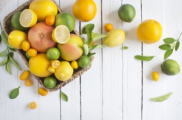 Citrus fruits family on rustic white wooden background. Horizontal view. Text space images.