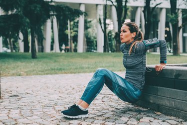 Woman doing dips outdoors