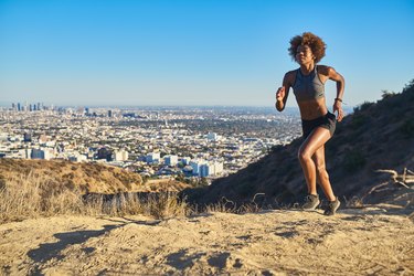 fit african american woman running at runyon canyon with los angeles