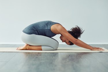 A woman doing yoga to help lower her blood pressure