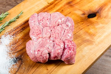 Raw lamb brains on chopping board