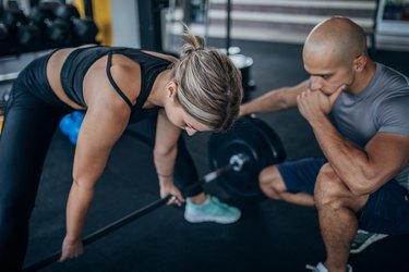 Woman practicing dead lifting