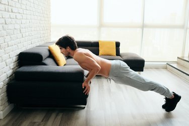 Man Training Chest And Biceps Doing Push-Ups With Backward Grip