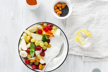 Top view full fruit breakfast and natural yoghurt bowl