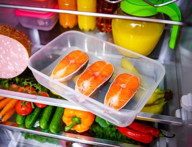 Raw Salmon steak in the open refrigerator