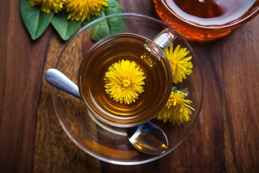 dandelion tisane tea with yellow blossom inside teacup