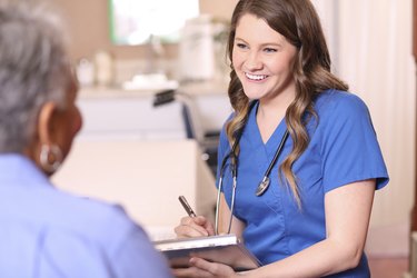 Doctor or nurse and senior adult patient in office, clinic.