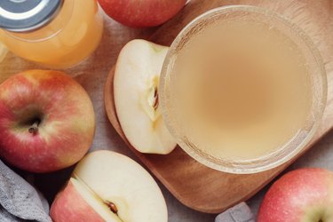 Apple cider vinegar with mother in glass bowl, probiotics food for gut health.