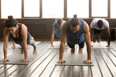 Group of young people standing in plank pose