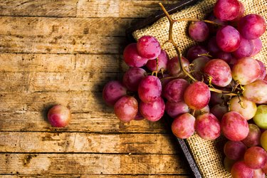 Fresh grapes on a rustic wooden background