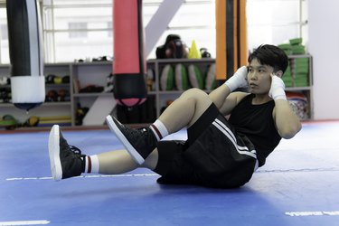 Boxer doing ab workouts in the afternoon at the gym