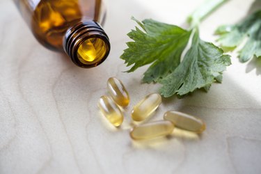 Capsules green in an open jar with leaf