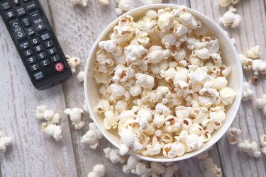 remote control and popcorn in a bowl