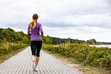 Young woman fast walking at seaside