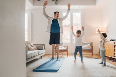 Father with children exercising at home