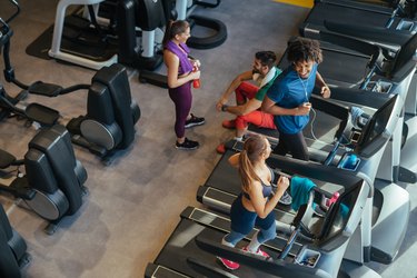 Young people in a health club exercising and resting