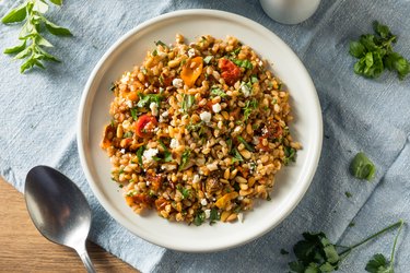Top view of a healthy homemade farro and tomato salad