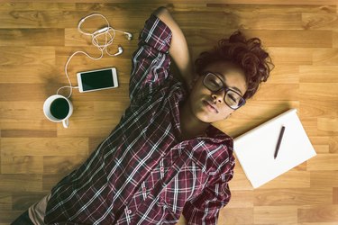 woman relaxing on floor taking a break from working doing box breathing