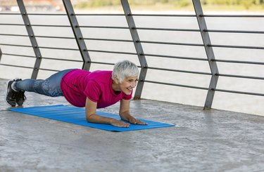 Senior adult woman exercising outdoors.